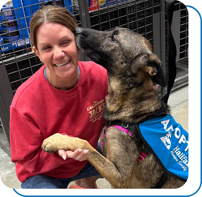 A woman getting a doggy kiss