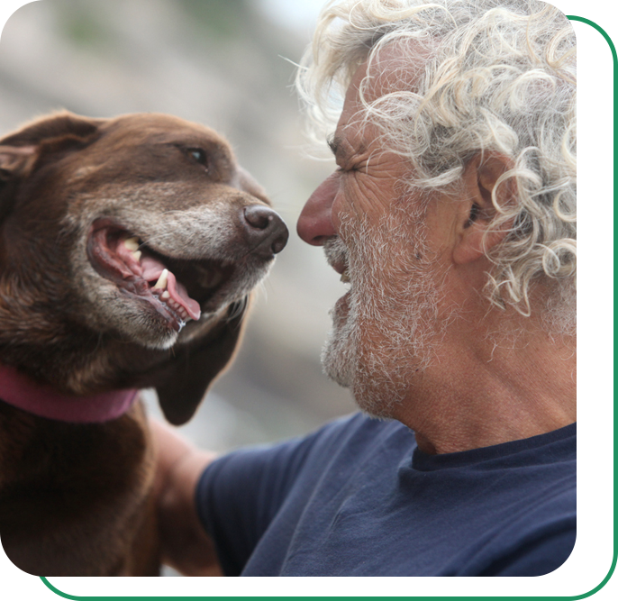 A man laughing with his dog